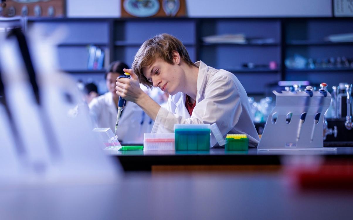 Student in biology lab using equipment