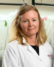 photo of Emily Chapman in lab coat